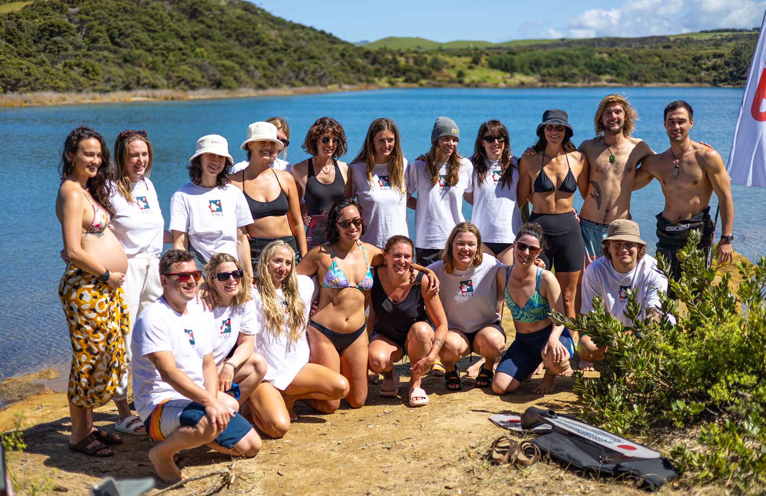 Group of people smiling by the water