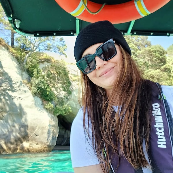 Shona sitting on a boat with a scenic background