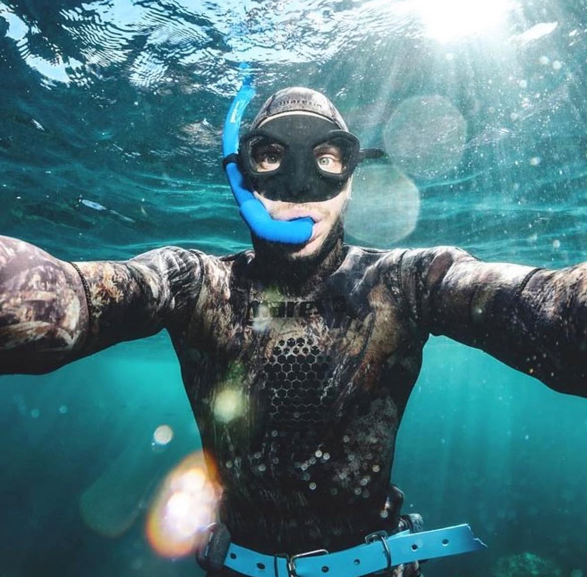 Dan wearing a wetsuit and snorkeling gear underwater
